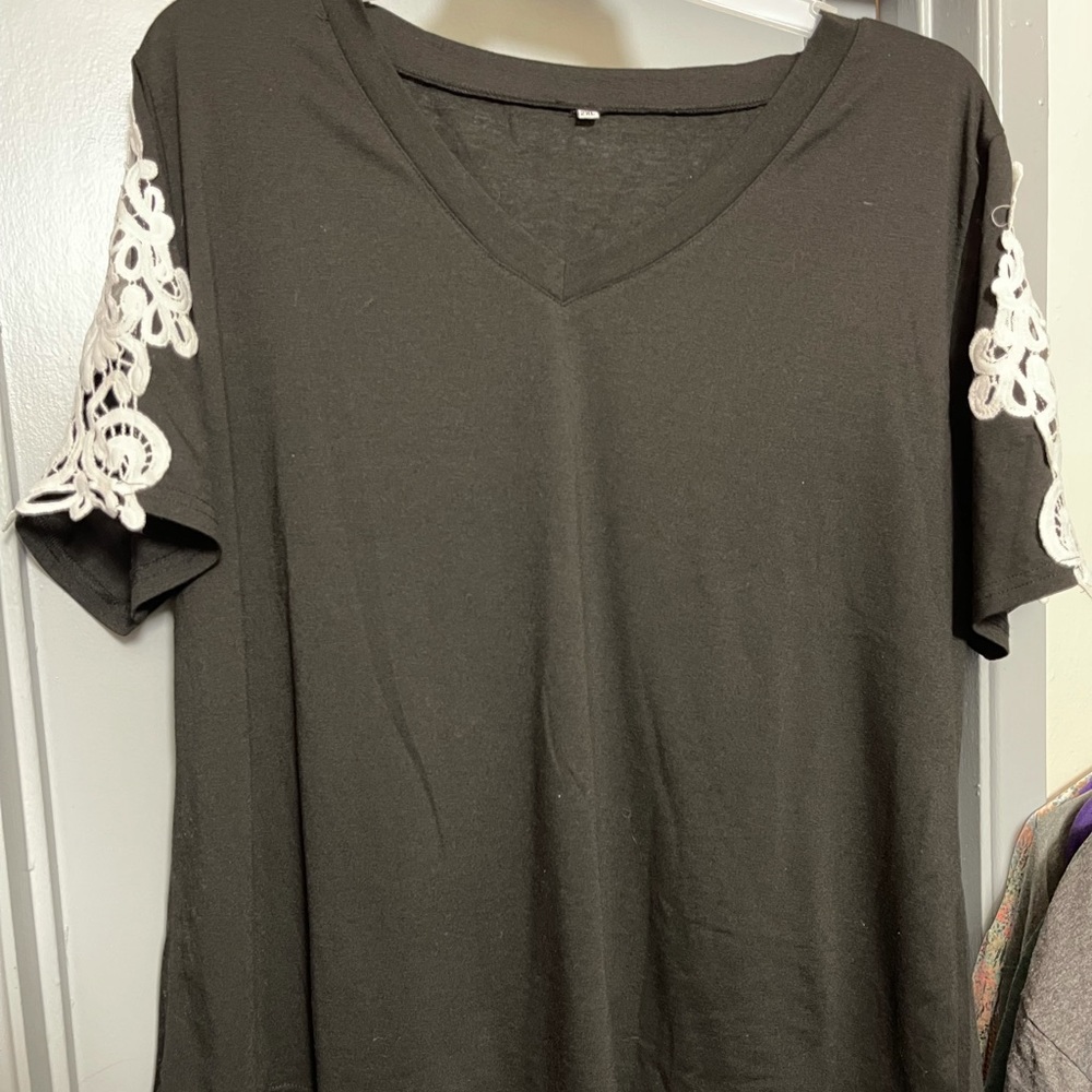 Black shirt with lace sleeves. It’s brand new but I don’t have the tags.